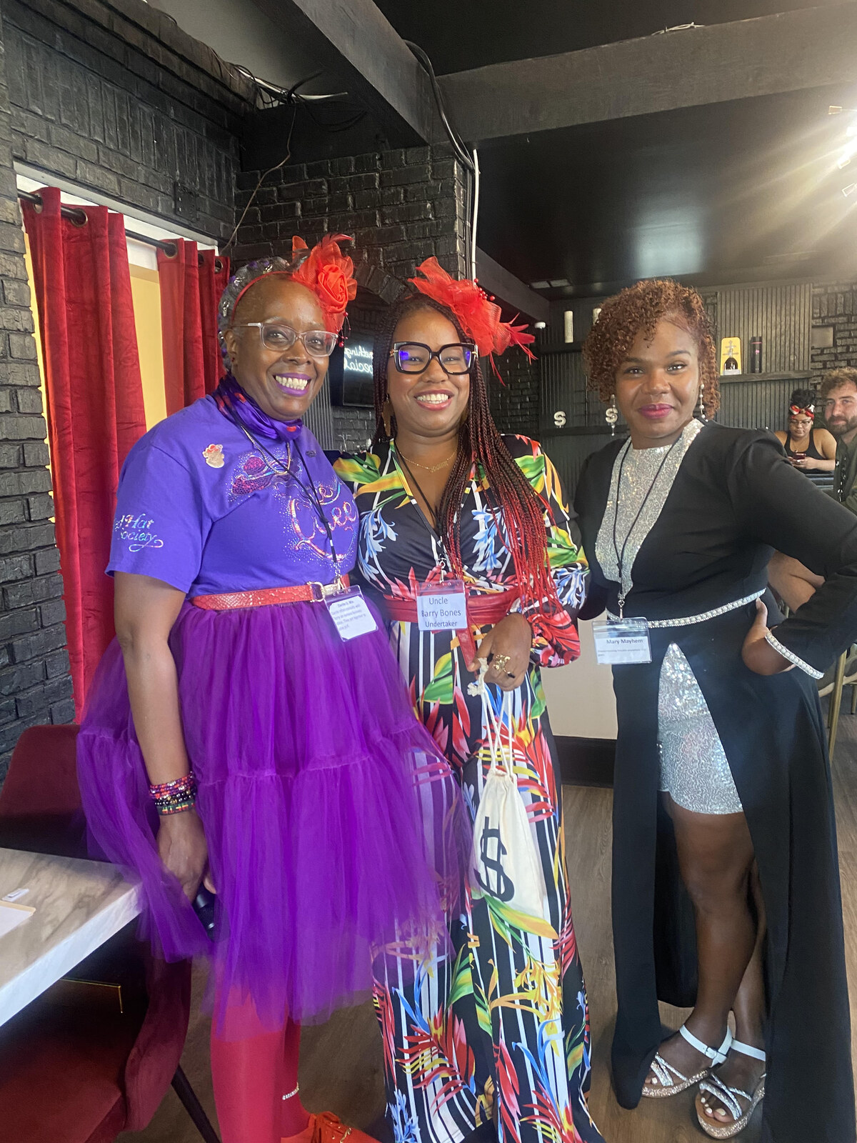 Shant’e Ragin smiling with Red Hat Society guests at an event